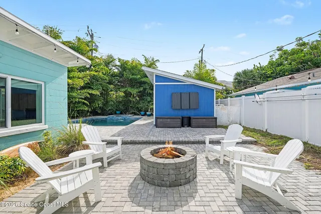 a view of a patio with couches table and chairs and potted plants