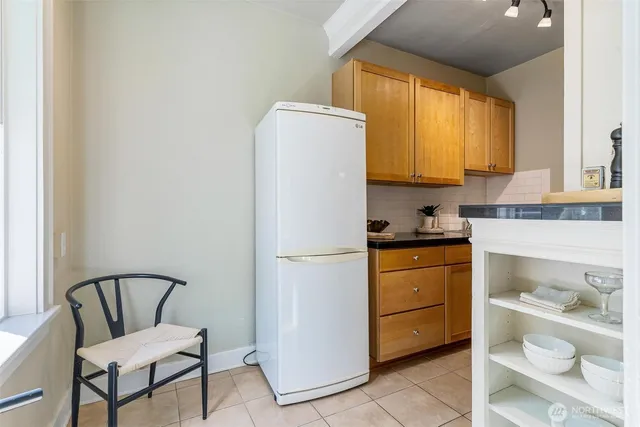 a white refrigerator freezer sitting in a kitchen