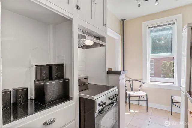 a kitchen with stainless steel appliances a stove a microwave and a refrigerator