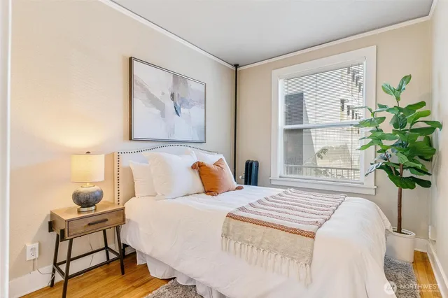 a bedroom with a bed and a painting on the wall