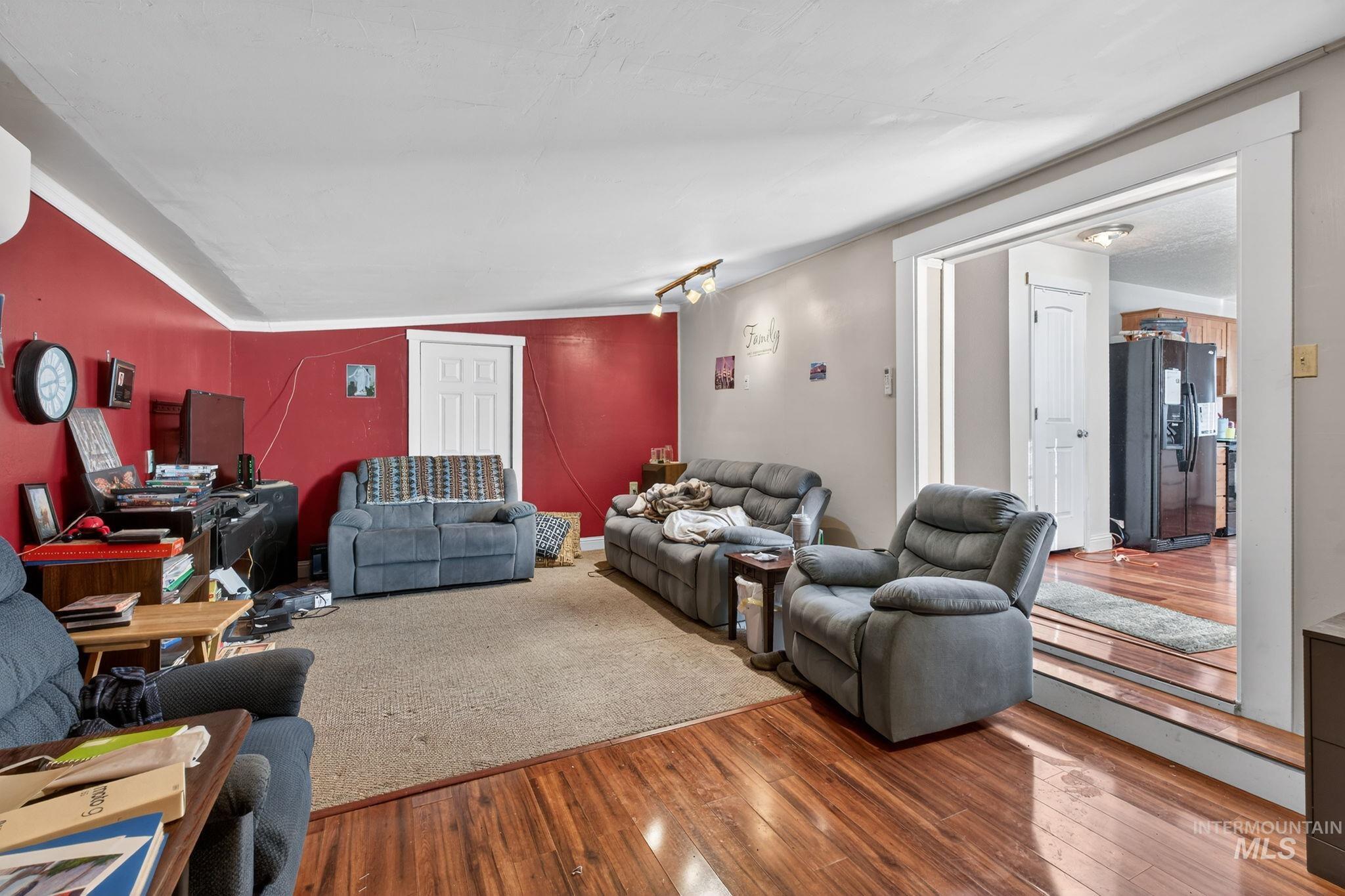 208 South 4th W Street Preston, ID 83263 - Photo 14 of 38 Living room with wood-type flooring and vaulted ceiling