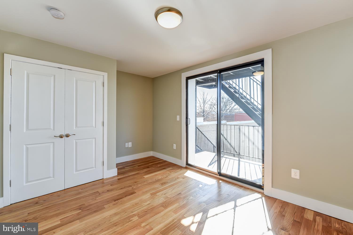 2031 Benning Road Northeast, Unit B Washington, DC 20002 - Photo 14 of 22 a view of an empty room with wooden floor and a window