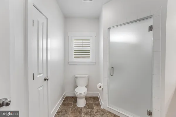a white toilet sitting next to a bathroom sink