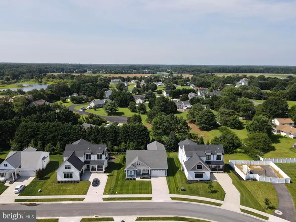 an aerial view of residential houses with yard