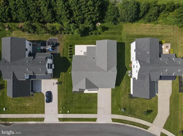 an aerial view of a house with a garden and lake view