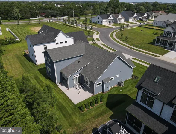 an aerial view of a house with a garden and lake view
