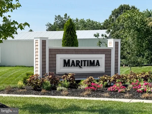 a sign that is sitting in front of flowers