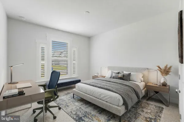 a bedroom with a bed a desk and chair