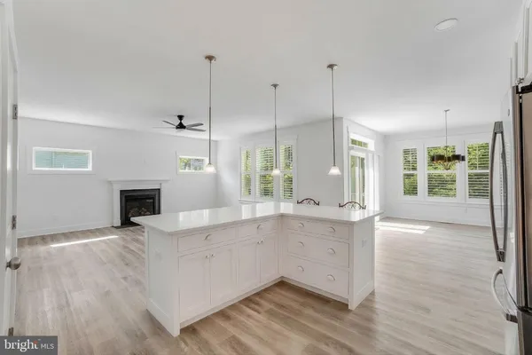 a view of a kitchen with a sink and a fireplace
