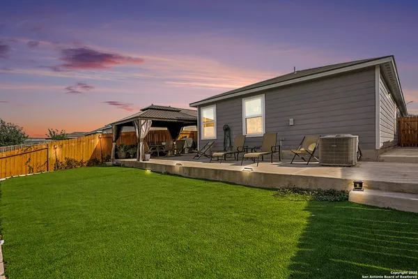 a view of a house with a yard porch and sitting area