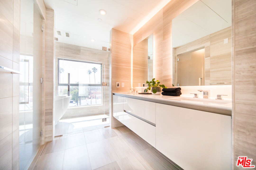 8600 Wilshire Boulevard, Unit PH17 Beverly Hills, CA 90211 - Photo 14 of 32 a large white kitchen with a large window and sink