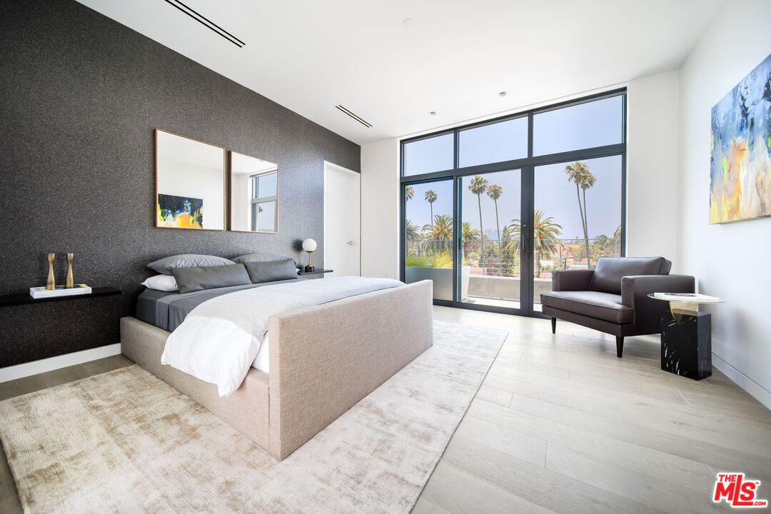 8600 Wilshire Boulevard, Unit PH17 Beverly Hills, CA 90211 - Photo 17 of 32 a bedroom with a large bed and a large window