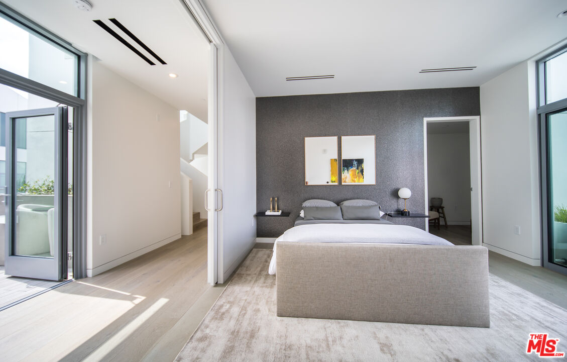 8600 Wilshire Boulevard, Unit PH17 Beverly Hills, CA 90211 - Photo 18 of 32 a bedroom with a bed and a dresser