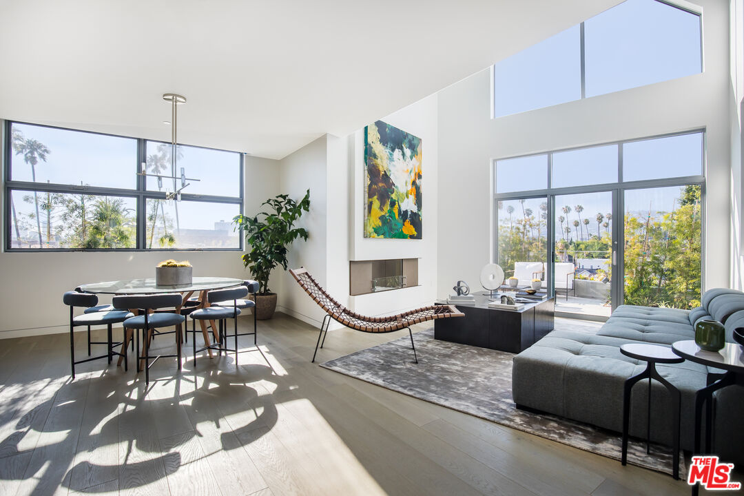 8600 Wilshire Boulevard, Unit PH17 Beverly Hills, CA 90211 - Photo 2 of 32 a living room with fireplace furniture and a large window