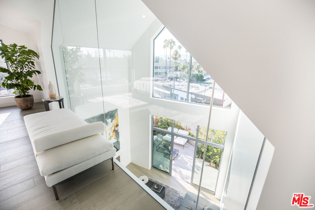 8600 Wilshire Boulevard, Unit PH17 Beverly Hills, CA 90211 - Photo 25 of 32 a living room with furniture and a large window