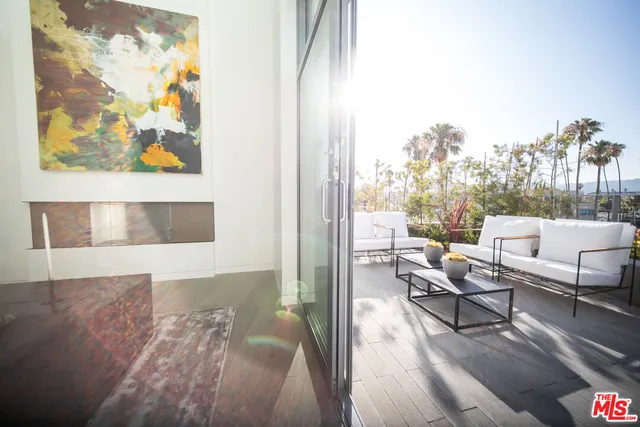 a living room with furniture and a painting on the wall