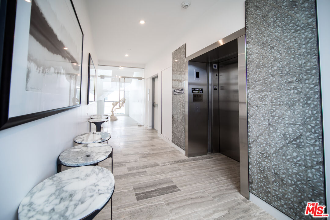 8600 Wilshire Boulevard, Unit PH17 Beverly Hills, CA 90211 - Photo 29 of 32 a living room with furniture and a wooden floor