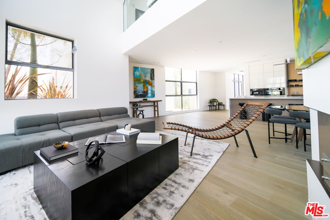 8600 Wilshire Boulevard, Unit PH17 Beverly Hills, CA 90211 - Photo 6 of 32 a living room with furniture and a window
