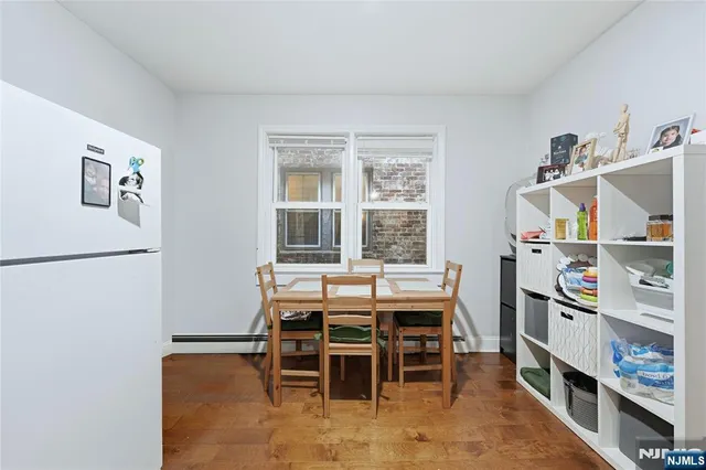 a view of a white house with a snow on the road