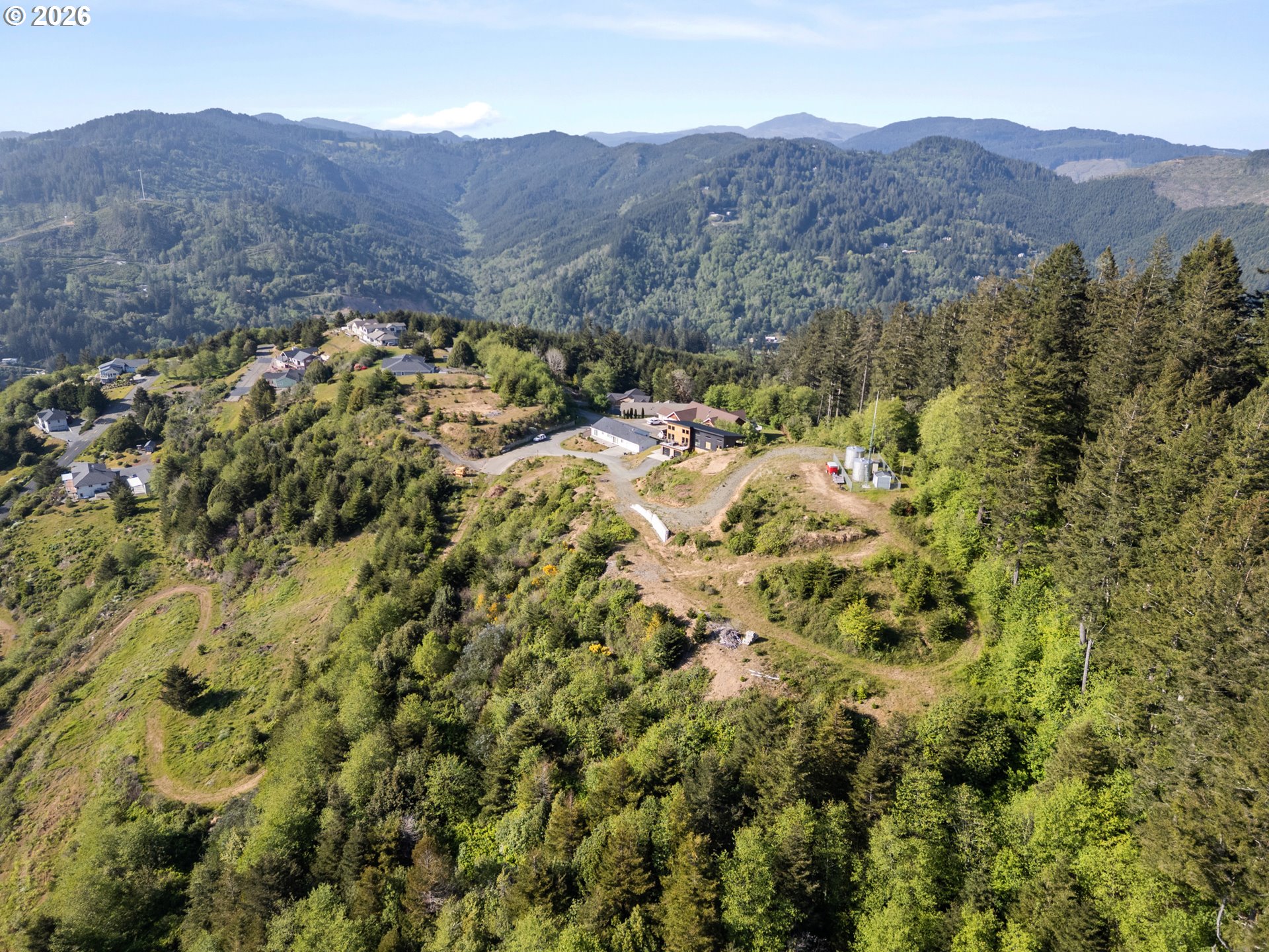 Jodel Court, Unit 2 Brookings, OR 97415 - Photo 4 of 14 a view of a lush green hillside and a houses