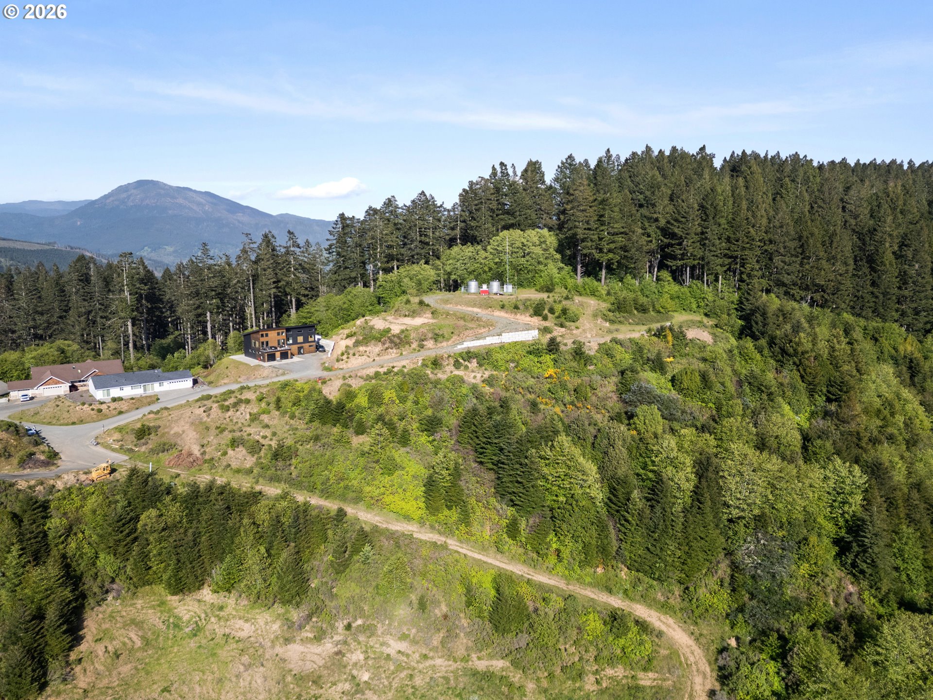 Jodel Court, Unit 2 Brookings, OR 97415 - Photo 5 of 14 a view of a backyard of a house with a mountain