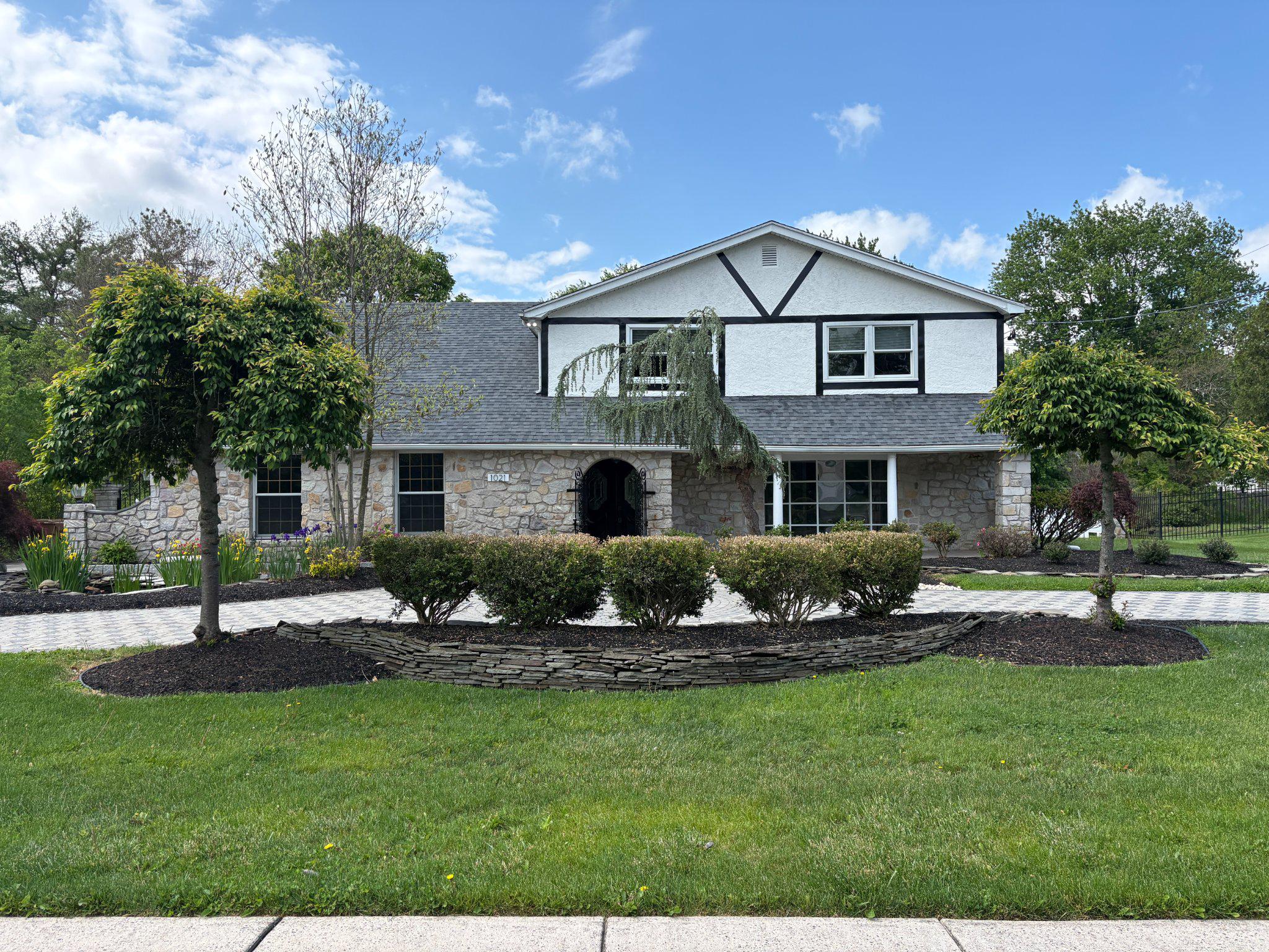 1021 Meetinghouse Road Ambler, PA 19002 - Photo 2 of 41 Charming stone facade with lush greenery.