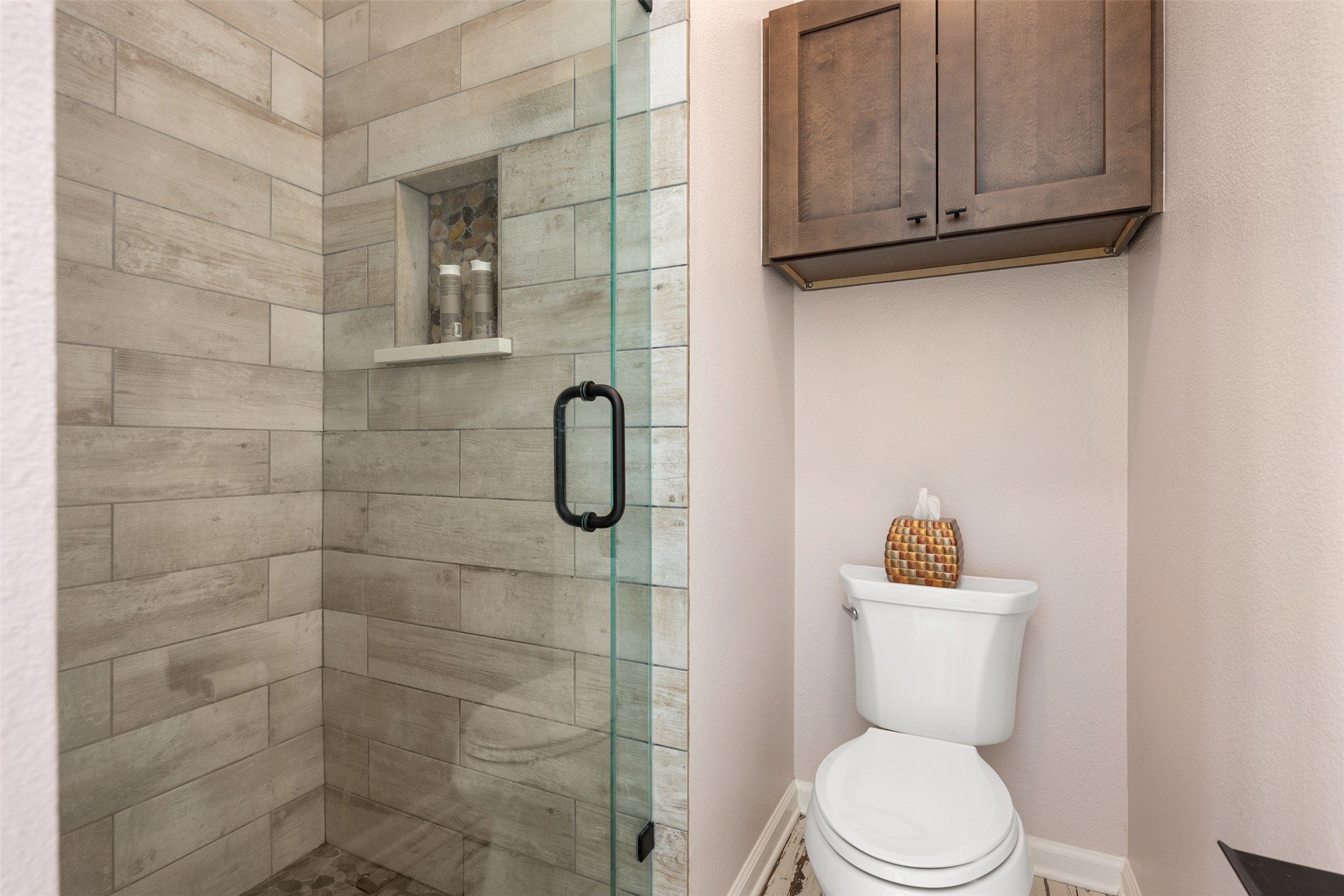 11203 Ranch Road 2222, Unit 1407 Austin, TX 78732 - Photo 13 of 40 A frameless glass enclosed walk-in shower comes surrounded in tile.