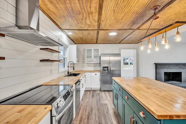 a view of a kitchen with a sink and cabinets