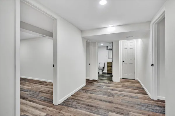 a view of a hallway with wooden floor