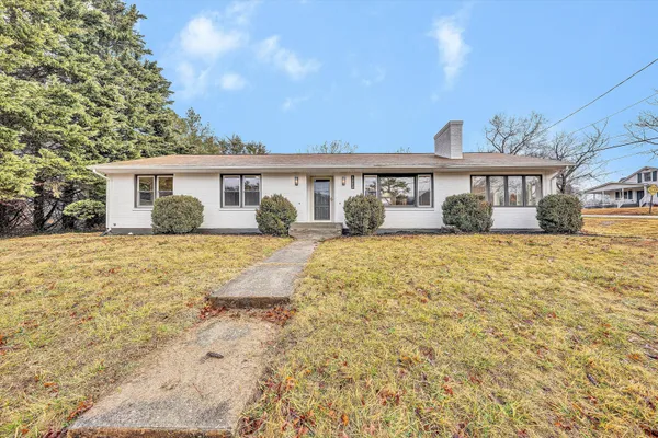 a front view of a house with a yard