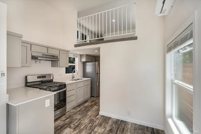 a kitchen with stainless steel appliances a stove and a refrigerator
