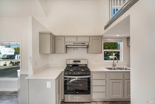 a kitchen with white cabinets and appliances