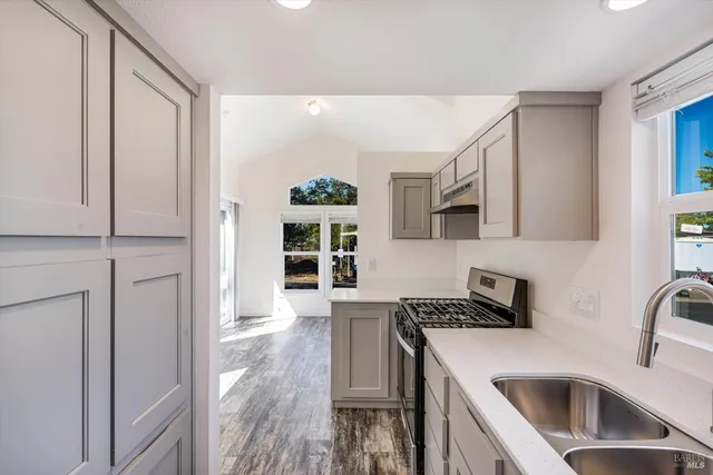 a kitchen that has a cabinets and a stove top oven