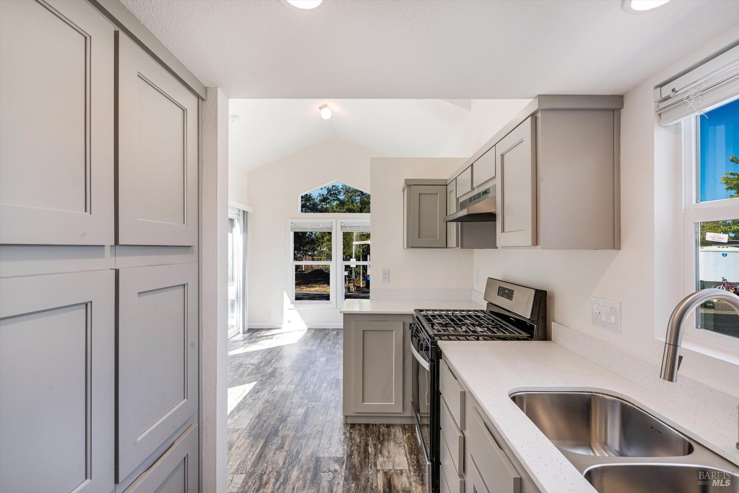 101 Colgan Avenue, Unit 2 Santa Rosa, CA 95404 - Photo 16 of 32 a kitchen that has a cabinets and a stove top oven