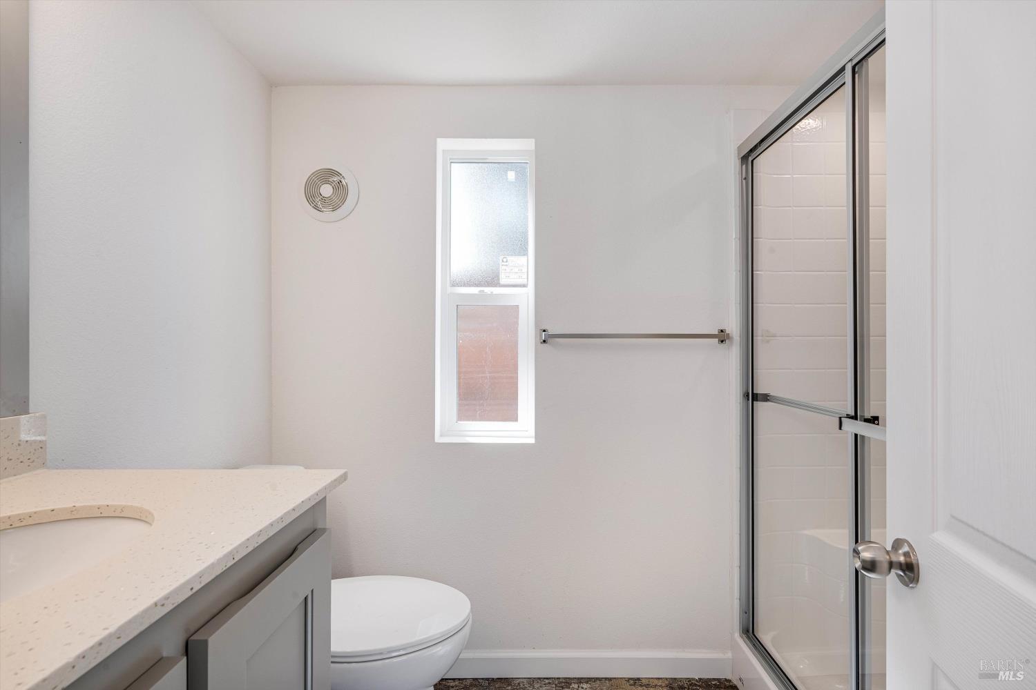 101 Colgan Avenue, Unit 2 Santa Rosa, CA 95404 - Photo 19 of 32 a bathroom with a granite countertop sink toilet and shower