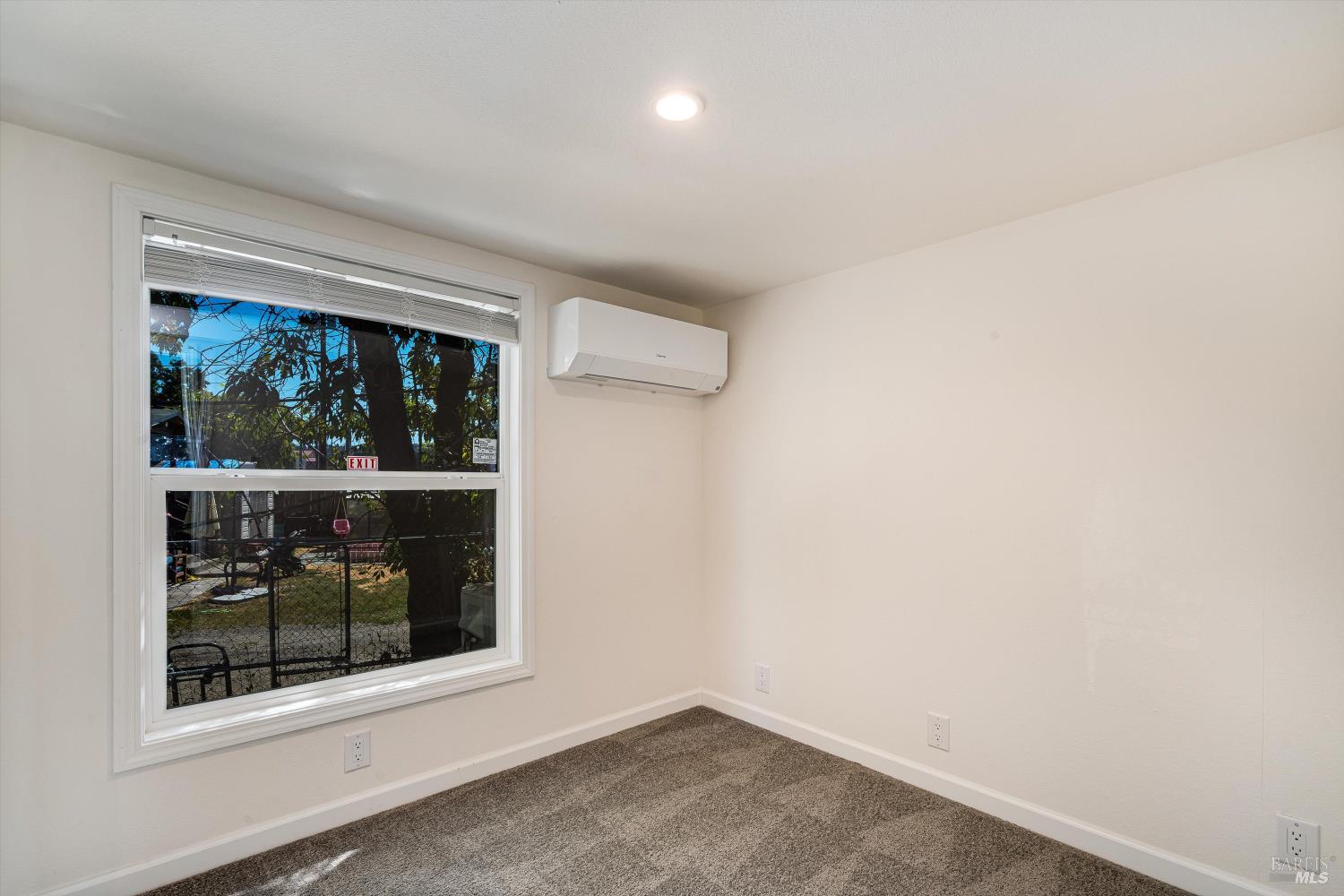 101 Colgan Avenue, Unit 2 Santa Rosa, CA 95404 - Photo 21 of 32 an empty room with wooden floor and a window