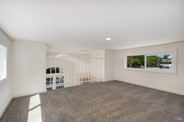 an empty room with windows and entrance