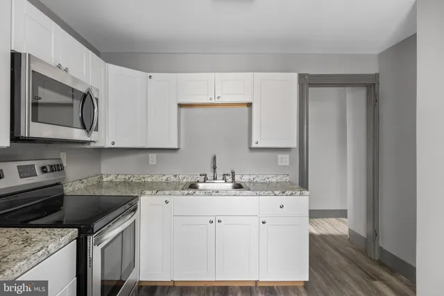 a kitchen with a sink stove and microwave