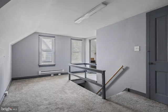 a view of an empty room with windows