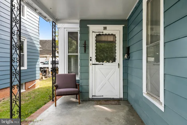 a view of porch with a bench and potted plant windows