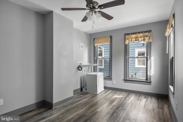 a view of a room with wooden floor and windows