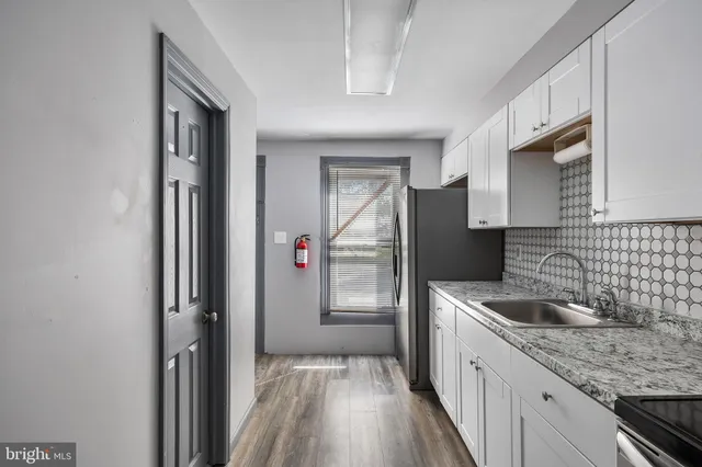 a kitchen with a sink and refrigerator