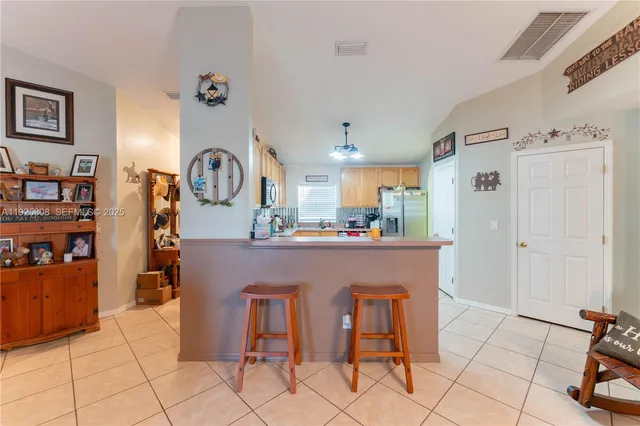 a view of kitchen with cabinets and window