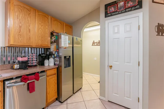 a kitchen with stainless steel appliances granite countertop a refrigerator and a stove
