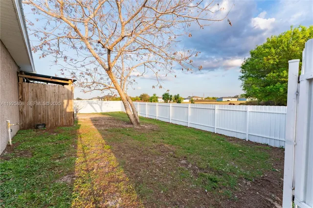 a view of a backyard with large trees