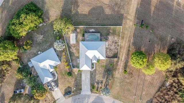 aerial view of a house with a yard