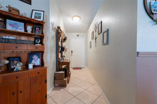 a hallway with wine cabinets and a window