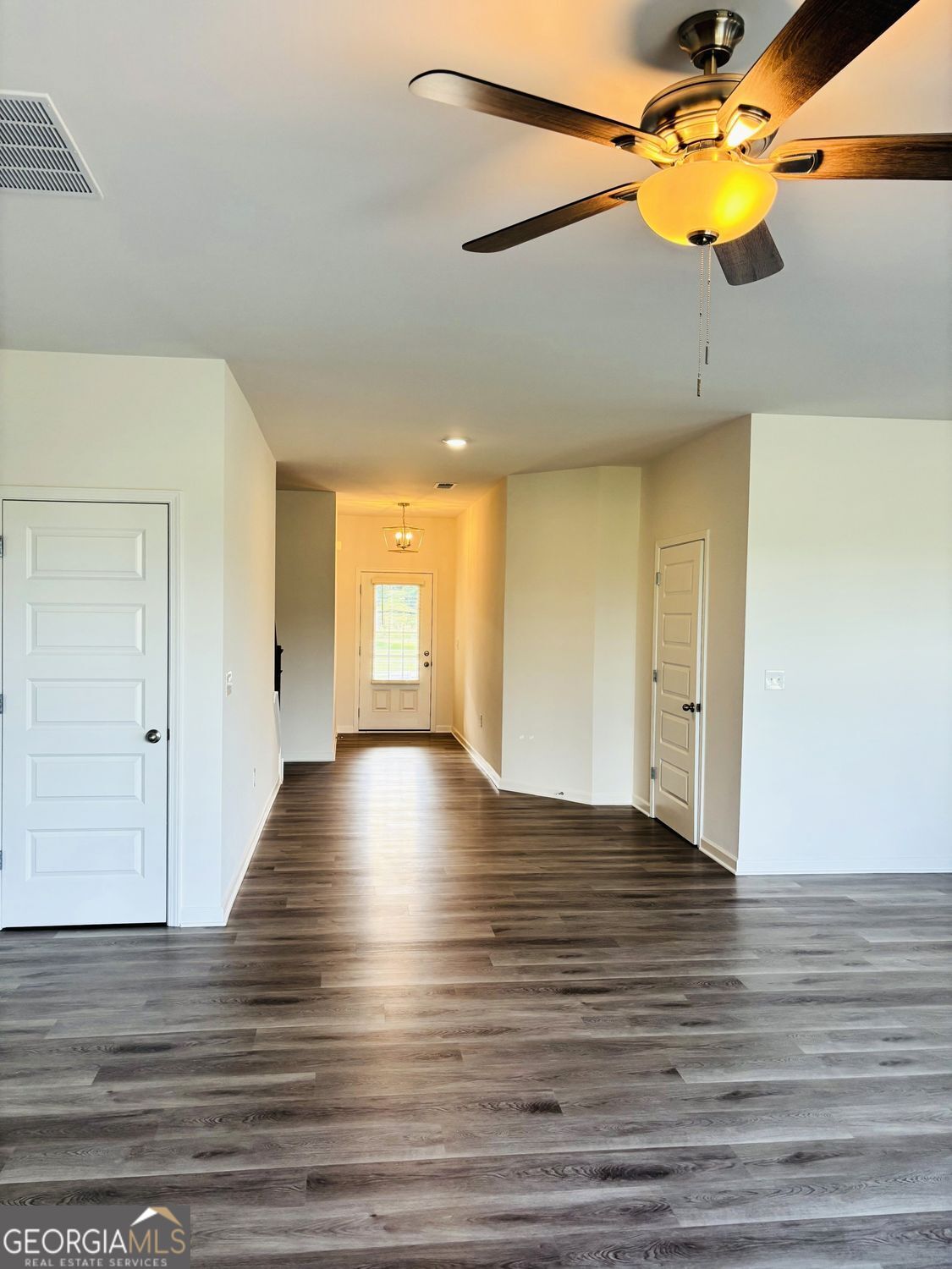 5984 Spring Way Lithonia, GA 30038 - Photo 2 of 17 a view of empty room with wooden floor and fan