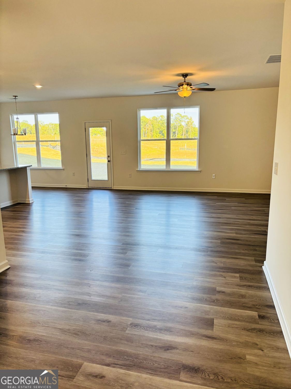 5984 Spring Way Lithonia, GA 30038 - Photo 3 of 17 an empty room with wooden floor and windows