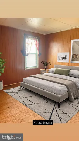 a bedroom with a bed and a potted plant on the dresser